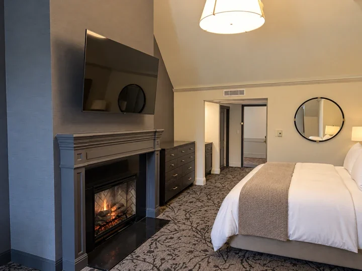 Guestroom with fireplace, television, dresser and bed during project work at Lafayette Park Hotel & Spa, Lafayette, California