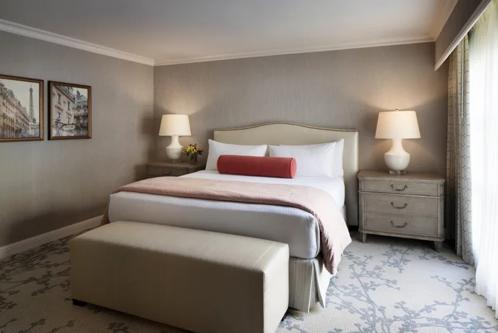 Guestroom with upholstered headboard, bedside tables and bench at Lafayette Park Hotel & Spa, Lafayette, California
